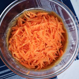 Add the grated carrot to the batter and stir completely.