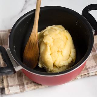 Put the batter on the heat after you mixed everything perfectly. Stir until your dough forms into a ball in a corner of your pan. take it away from the heat and give it some time to cool down. You can move it to another dish to become cool sooner.