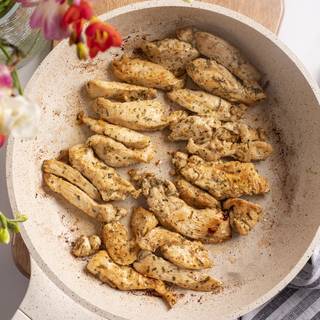 Saute chicken breasts with olive oil in a pan.