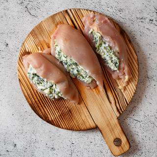 Spoon the spinach mixture into each chicken breast evenly until the edges come together and keep the ingredient within while frying. 