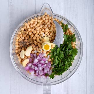 Mix chickpeas with parsley, onion, garlic, and spices with your food processor until they are completely combined.