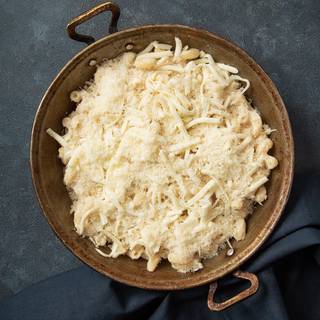 Preheat the oven to 180C. Cover the pasta with cheese and let it be cooked in the oven for half an hour.