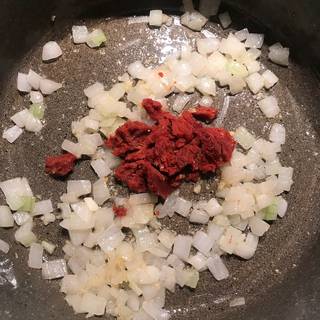 Add the tomato paste in the skillet, stir to combine and saute for about 2 minutes.