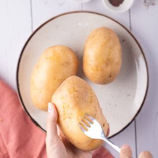 First wash the potatoes to make them perfectly clean, dry them with some paper towel then poke them with a fork. 