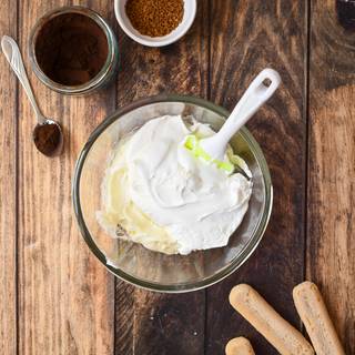 Add the whipped cream to the cheese and sugar powder mixture and put it in the freezer for 30 minutes, then mix everything with a mixer.