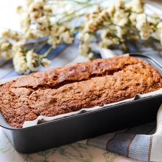 put the loaf pan into a preheated oven at 170°C (340°F) for 50 minutes. For testing, dip a wooden stick into the cake and if it comes out clean, that means that the bread is ready and if it didn't, put it back into the oven again.