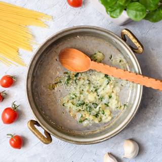 Fry the grated onions in a greased pan until they become golden. Add the grated garlic to the onions and fry them until their smell fills the air. Now add the chopped parsleys to your pan.