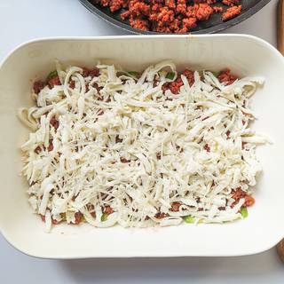 Pour A proper amount of grated mozzarella cheese on the top of the layers and spread it well.