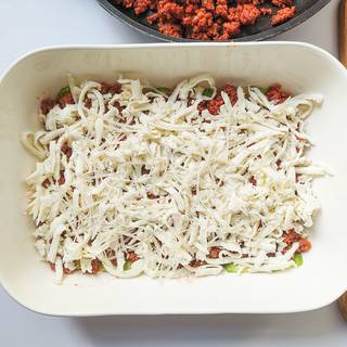 Pour A proper amount of grated mozzarella cheese on the top of the layers and spread it well.