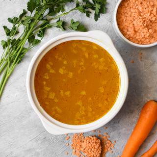 Pour 2 cups of water or bouillon in your pot and wait until it comes to a boil. Now add the red lentils to cook.