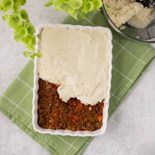 Fill a proper dish with the beef and cover it with the cauliflower topping completely.