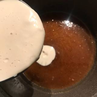 Remove the saucepan from the heat and add the heavy cream immediately and stir continuously.