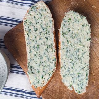 Cover the bread with butter, garlic, and parsley mixture.