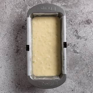 Cover the loaf pan with parchment paper and pour the batter inside it.