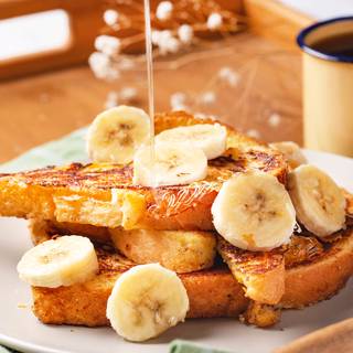 Shake off the excess egg mixture from the bread, and place the bread slices onto the hot skillet. Fry the French toast until browned on one side, then flip and brown the other side. 