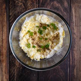 Mince the spring onions and add them to the eggs with spices. 