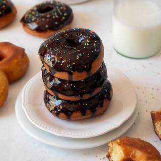 You can decorate your doughnuts with chocolate sauce, colored truffles, pistachio powder, or anything you desire and then serve them.