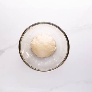 Take the dough out of the bowl and knead it on a surface for 10 minutes.