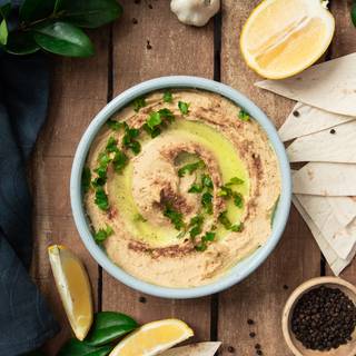 For decorating your hummus you can use olive oil, red pepper, and sliced parsley.