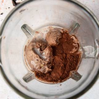 Add ice cream, milk, and cocoa powder to the blender. 