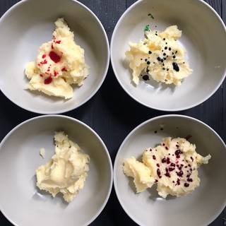 Add a few drops of food coloring to each bowl. Stir with a spoon until you achieve your desired colors.
