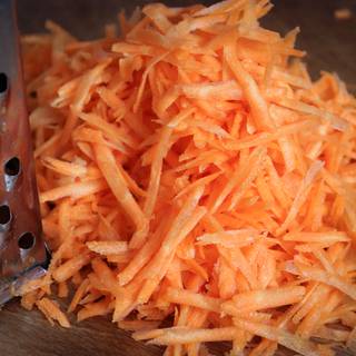 Grate the carrots with large holes.