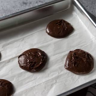 Take a teaspoon or a scoop of dough and place it on the oven tray at intervals. making sure to space them evenly, leaving enough room for spreading. Put the tray in the preheated oven at 330 Fahrenheit for 10 to 12 minutes.