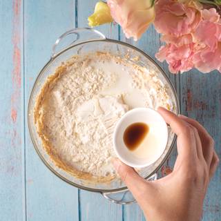 Add the cooled cooked flour, vanilla, and milk and mix them.