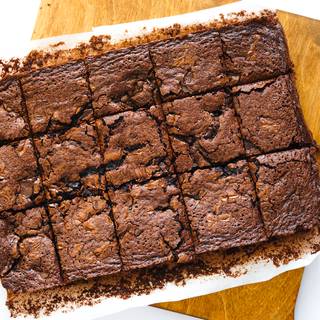 Let your brownie cool a bit then remove the paper and cut it.