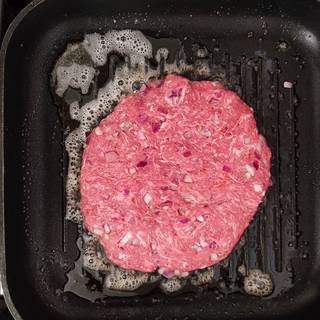 Grease a pan with some butter. Remove the parchment paper from the patties and fry them.