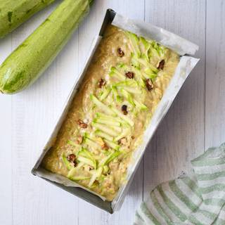 Grease your medium-sized loaf pan and cover it with parchment paper. Pour the dough into the pan and bake it for 40 to 60 minutes at 175°C inside the oven.