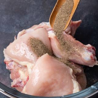 Marinate the chicken with salt, pepper, and garlic powder and let it rest in the dish.