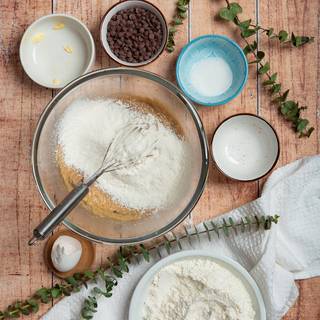 Now you can add sifted flour slowly to the ingredients.