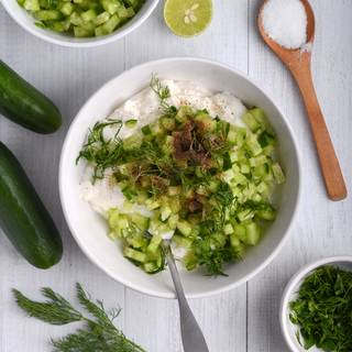 Add the parsley and dill leaves, black pepper, salt, some fresh lemon juice, and garlic powder to the yogurt and mix well.