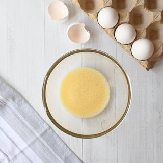 Crack one of the eggs onto the bowl and stir it until bubbles appear on the top of the mixture.