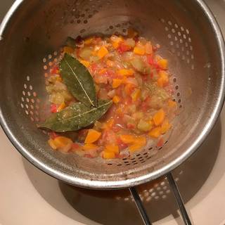 Pour the sauce through a fine-mesh sieve into a bowl to discarding solids.