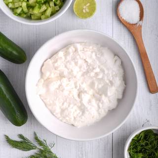 Wash the cucumbers and grate them or cut them into small cubes and mix with the yogurt in a bowl. Wash the parsley or dill leaves, drain and mince them.