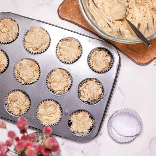 Pour the batter inside the cupcake papers inside the tin. fill 2/3 of the cupcake papers.