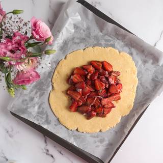 Put strawberries in the middle of the dough. But from each side, there should be 3-centimeter space. 