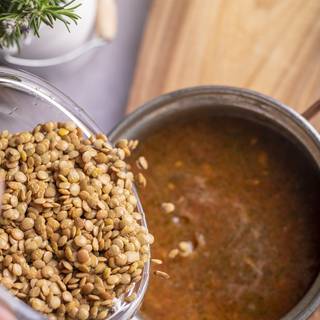 Wash lentils with cold water, drain them, and add them to soup, then add pepper and salt. When the water starts boiling, lower the heat and let the soup cook for 45 minutes.