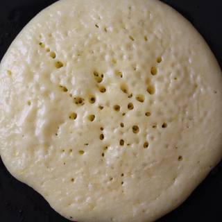 Cook until the surface of pancakes has some bubbles and a few have burst. Flip it over and cook until browned on the underside,