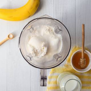 In this step, add 3 scoops of ice cream, and vanilla to milk and banana then mix them completely. Now we can add sugar or honey to them as desired.