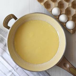 Coat the surface of the pan with butter and let it heat for a while. Now pour 2 cups of the mixture onto the pan and swirl it until it covers the pan. When the ages of the crepe starting lightly to brown and bubbles appear on top of it, flip until the other side of the crepe bake.