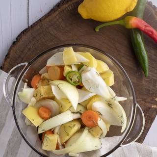 First, you need to chop the vegetables (potato, onion, carrot, half of the garlic, half of the green chili, and rosemary) into large pieces. Use half of the lemon juice to add to your vegetables.