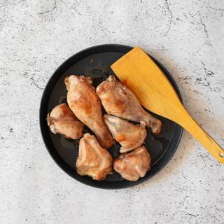 Season your chicken thighs with salt and pepper. Pour some olive oil into a pan and fry the chickens inside it.