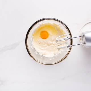 Mix the cream cheese with sugar until they are combined well. Add the eggs one by one and stir them until they are perfectly mixed.