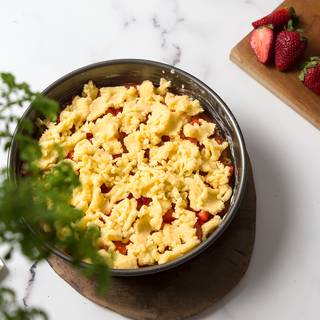 Cover the strawberries with 1/3 of the remaining dough. Don't be afraid of using your hands, cut the dough to pieces and place them on the top of the filling.