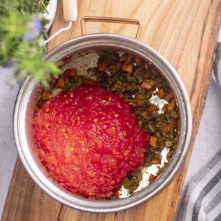 Dice the tomatoes with a food processor or a mixer and add them to the vegetables. Cook them for 2 minutes, Then add 8 cups/1 liters of water to the pot.