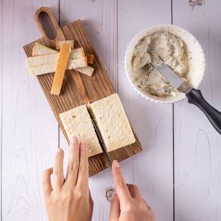 Cut the edges of the bread with a sharp knife to make them softer.