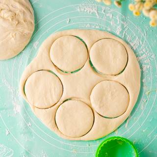 You can take the dough out after one hour. sprinkle your surface with some flour, roll out the dough and cut it into circles with a round cookie cutter.